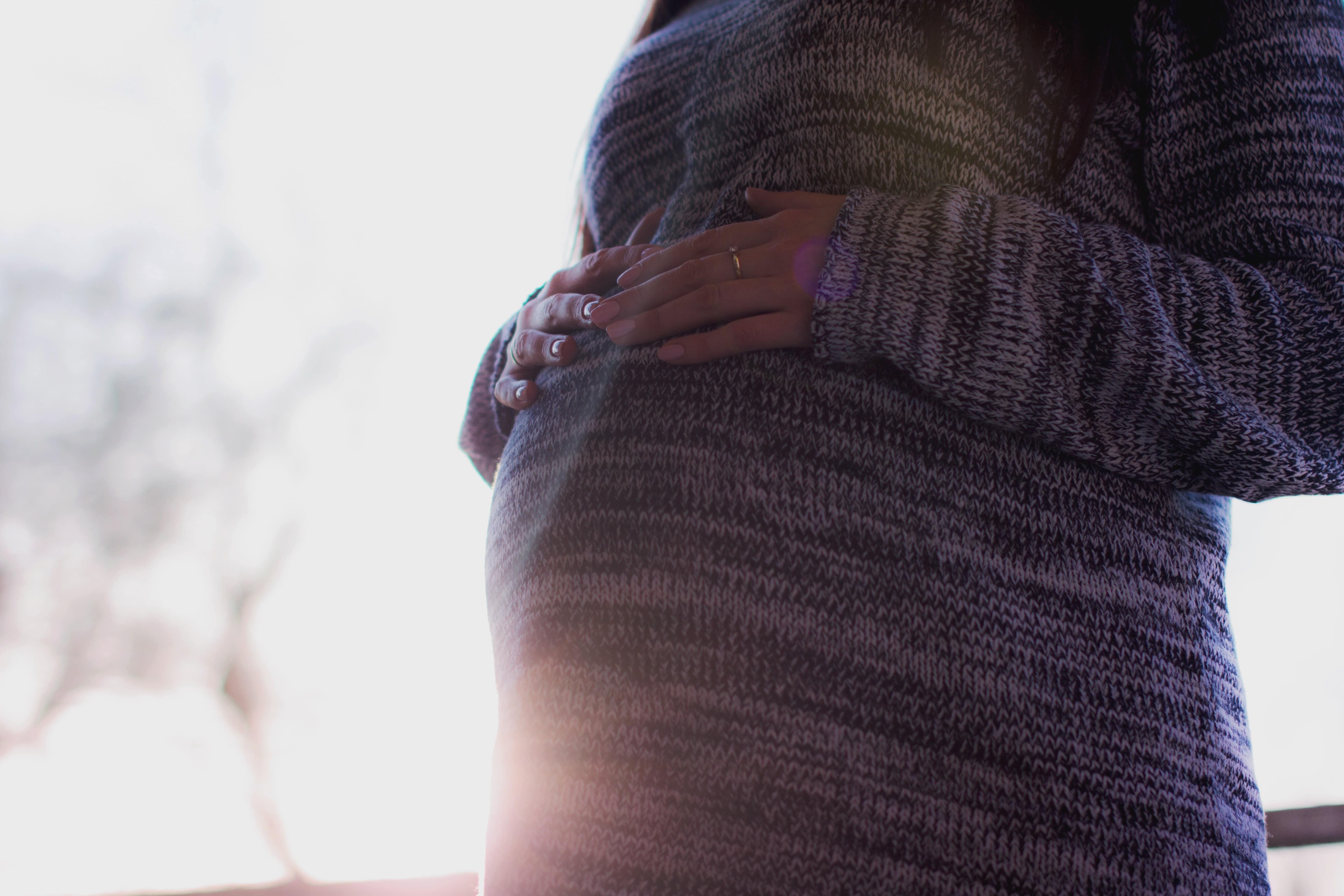 Pregnant woman holding her stomach