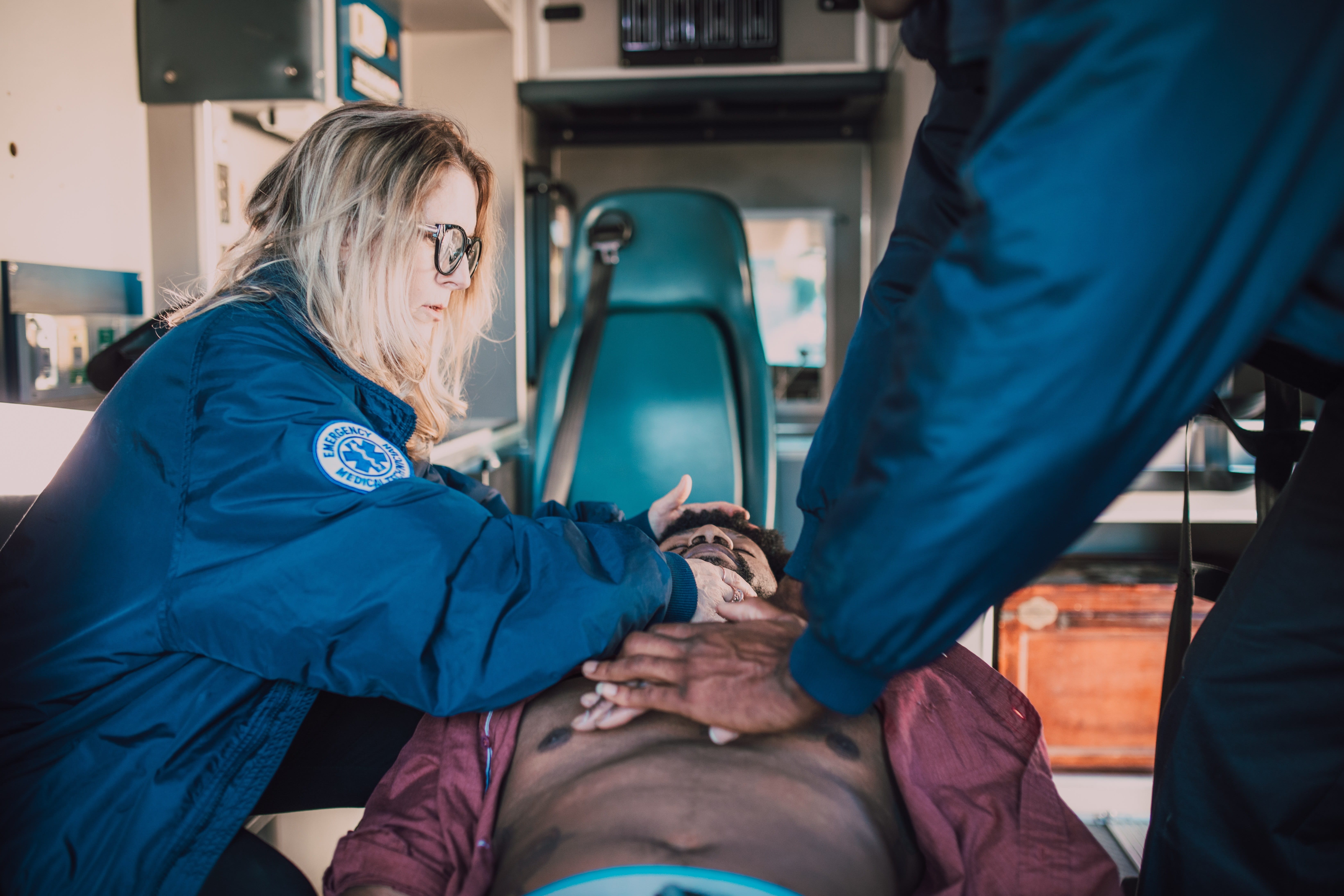 EMS team assisting a patient in an ambulance