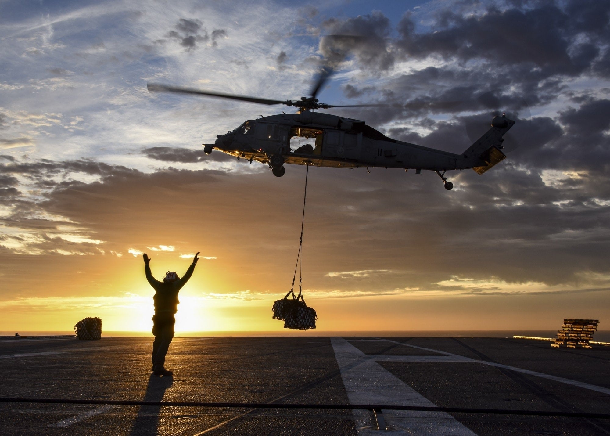 Military helicopter delivering supplies