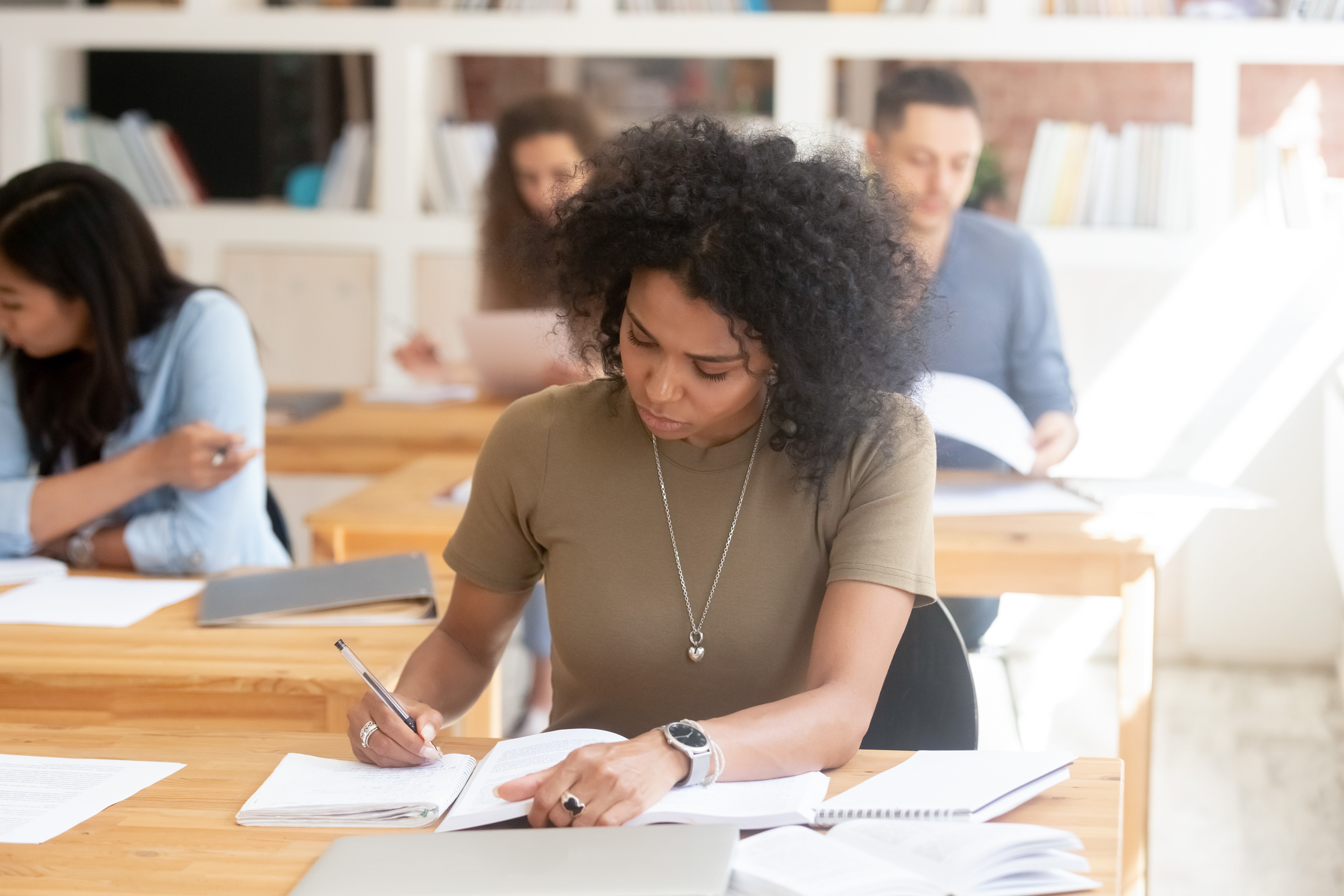 African-American student writing in a notebook