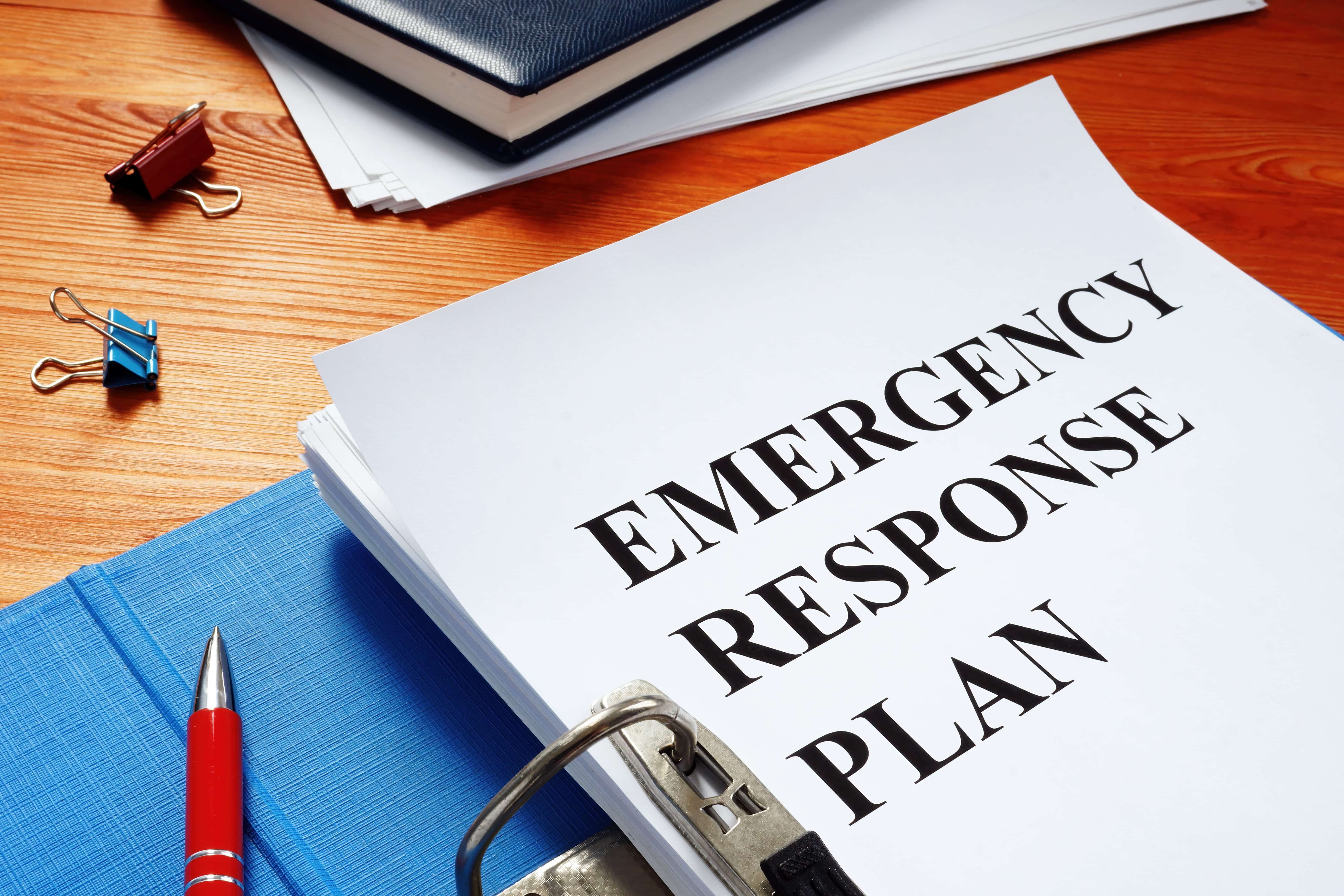 Binder with papers that say emergency response plan