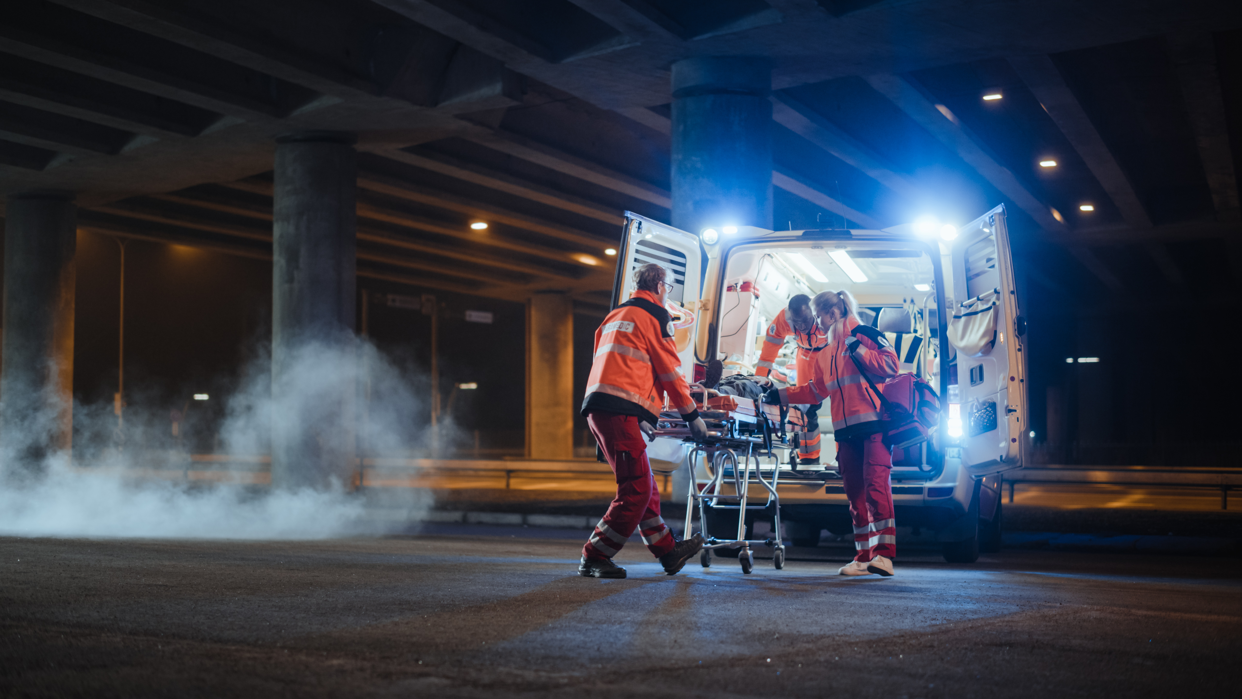 Team of EMS professionals helping an injured person