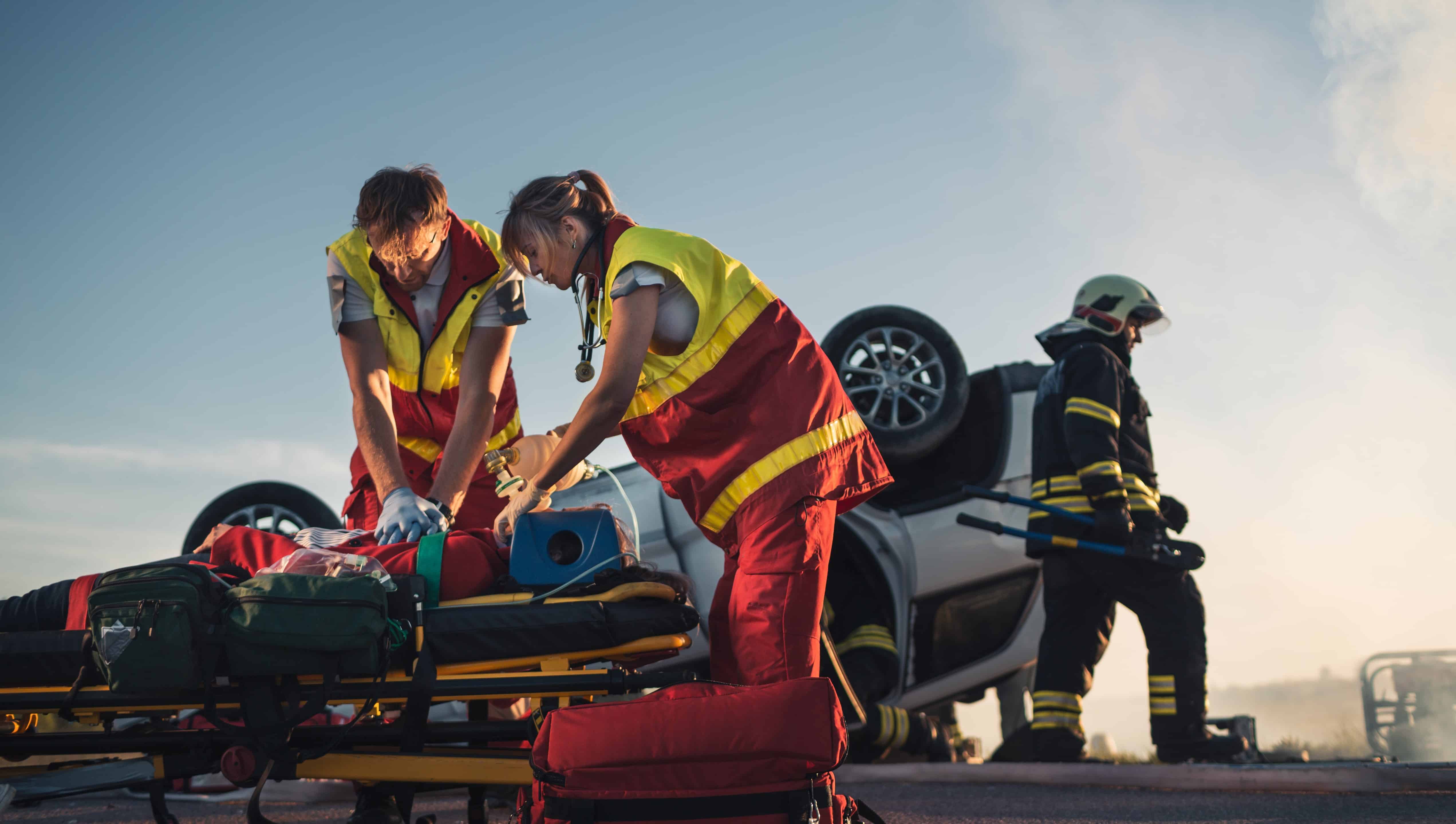 EMS team providing aid to a car crash victim