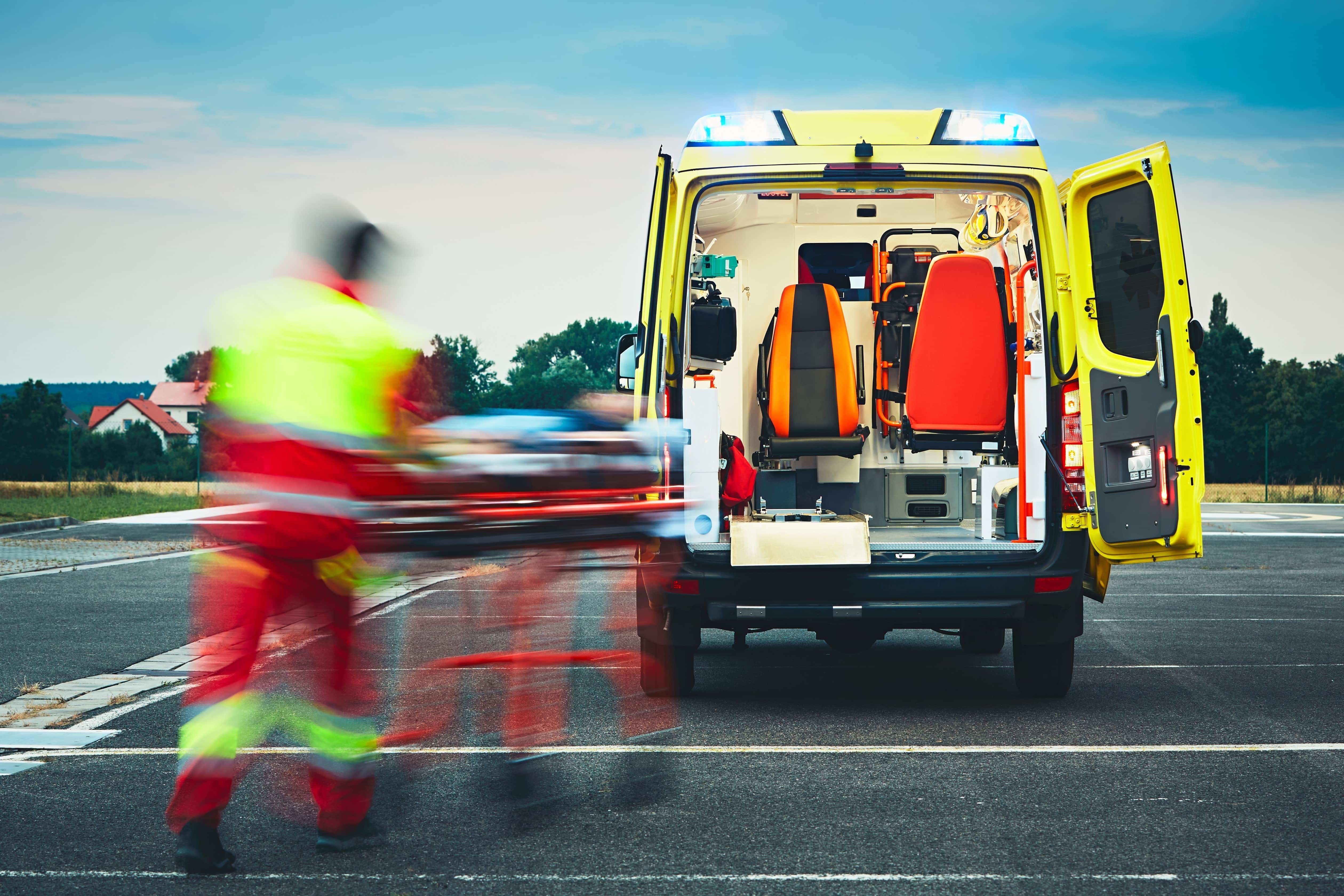 Blurred paramedic transporting a patient to the ambulance