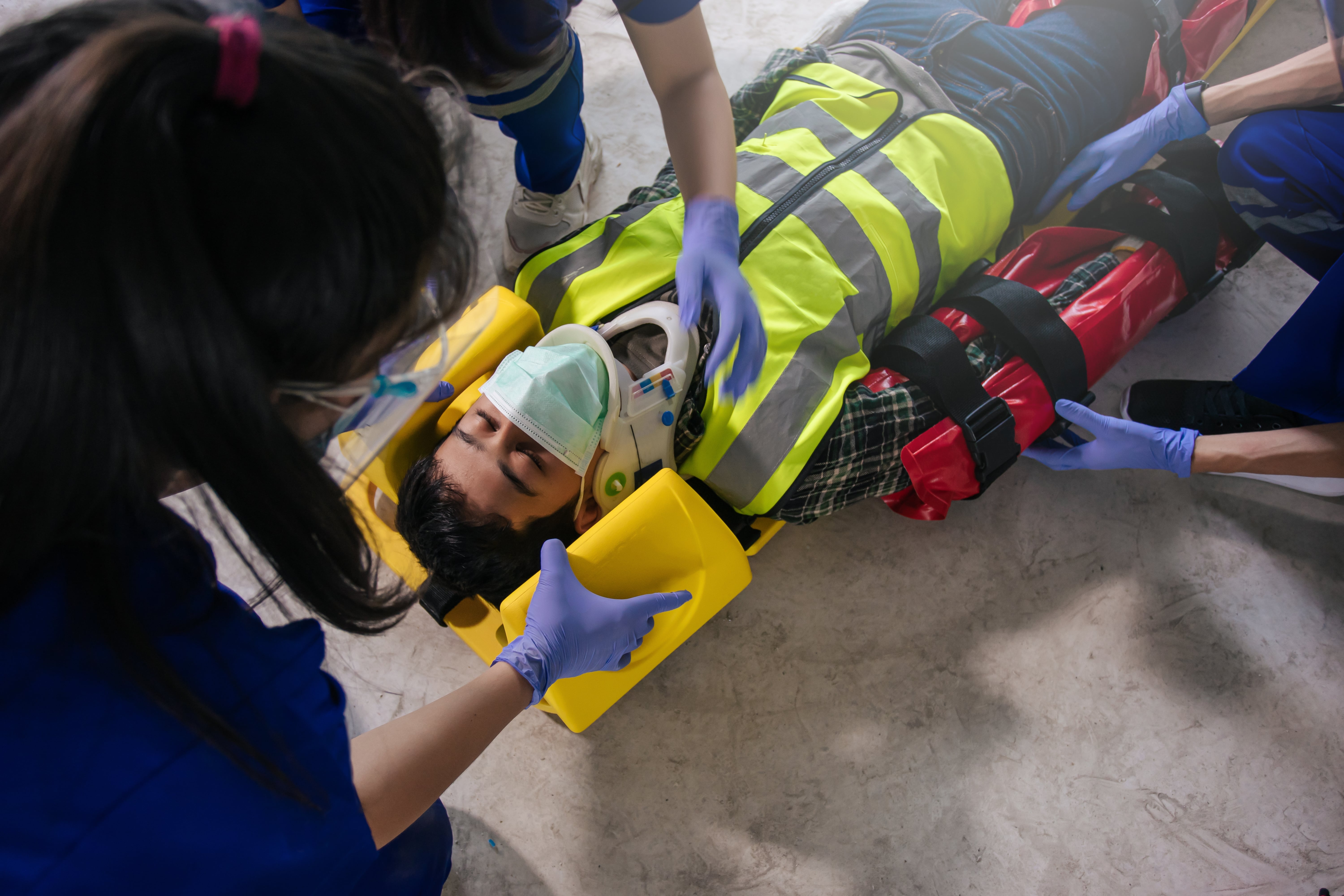 Close up of EMS professionals stabilizing a car crash victim